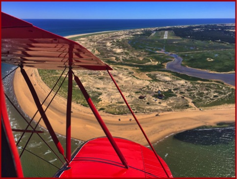 biplane over dunes